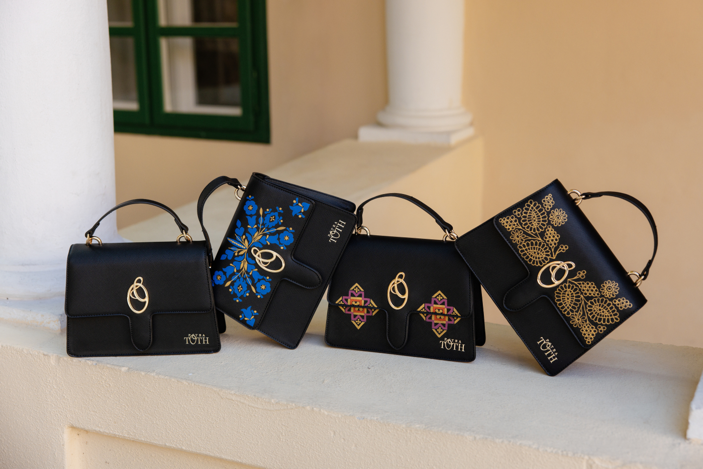 Black top-handle bag with gold logo